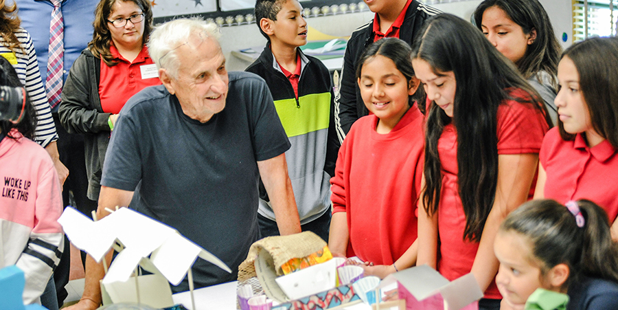 Frank works with students on a Build a City Project