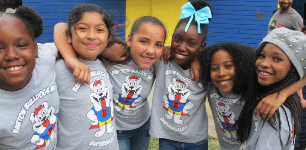 young students hugging each other