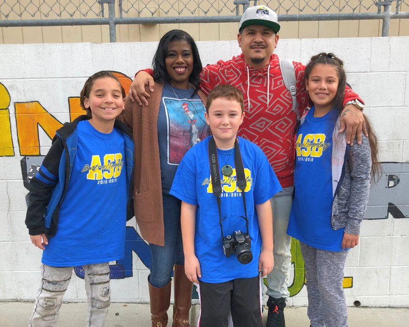 Two teachers pose with three students